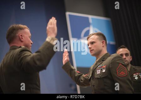 U.S. Marine Col. Philippe Rogers, U.S. Military Delegation to the North Atlantic Treaty Organization (NATO) Chief of Staff, conducts a Re-enlistment ceremony for Staff Sgt. Matthew Leonard, U.S. Marine Guard detachment of the U.S. Embassy to NATO,  at NATO Headquarters, May 17, 2017. (DoD Stock Photo