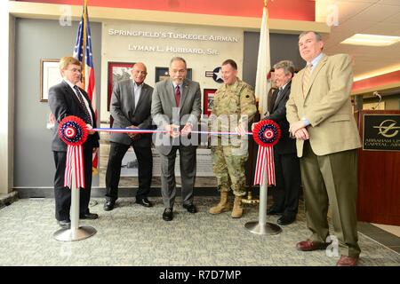 Lyman L. Hubbard Jr. (center), joined by (from left) Mayor James O. Langfelder, City of Springfield, Lee Hubbard, son of Lyman Hubbard Sr., Maj. Gen. Richard J. Hayes, Adjutant General, State of Illinois, Brian McFadden, Sangamon County Administrator, and Col. (ret) Michael Meyer, Commissioner, Springfield Airport Authority, cuts the ribbon on the Lyman L. Hubbard Sr. memorial at Abraham Lincoln Capital Airport. Stock Photo