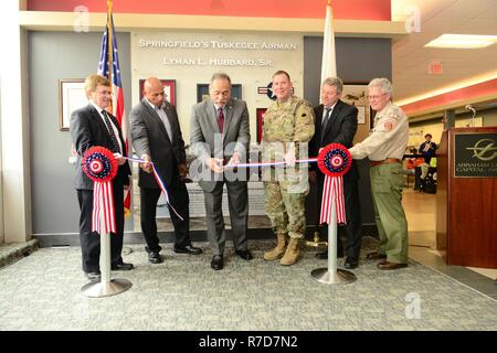 Lyman L. Hubbard Jr. (center), joined by (from left) Mayor James O. Langfelder, City of Springfield, Lee Hubbard, son of Lyman Hubbard Sr., Maj. Gen. Richard J. Hayes, Adjutant General, State of Illinois, Brian McFadden, Sangamon County Administrator, and Mr. Dan O'Brien, Executive Director, Abraham Lincoln Council, Boy Scouts of America, cuts the ribbon on the Lyman L. Hubbard Sr. memorial at Abraham Lincoln Capital Airport. Stock Photo