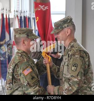 Ansbach, GERMANY – Col. Richard A. Wholey, Jr. (left), commander of the 678h Air Defense Artillery Brigade, passes the battalion colors to Lt. Col. Todd Daniels, commander of the 5th Battalion, 4th Air Defense Artillery Regiment, during the 5-4 ADA activation and assumption of command ceremony on Shipton Kaserne, Germany Noveber 28. Daniels is the first commander of the newly activated brigade after 20 years of lying dormant. ( Stock Photo