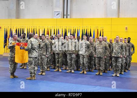 Col. Thomas E. Moore (front left), commander, 174th Air Defense Artillery Brigade, Ohio Army National Guard, and Command Sgt. Maj. Dwight S. McCandless, command sergeant major, 174th ADA BDE, uncase the unit colors during a transfer of authority ceremony on Katterbach Kaserne, Nov. 28, 2018.  Col. Richard A. Wholey Jr., commander, 678th ADA BDE, South Carolina Army National Guard, relinquished command to Moore during the ceremony. Stock Photo