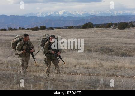 Staff Sgt. Levi McGowan and 2nd Lt. Bryan Tanguay, assigned to Bravo Company, 299th Brigade Engineer Battalion, 1st Stryker Brigade Combat Team, 4th Infantry Division, ruck march to their next event during the Best Sapper Competition, Fort Carson, Colorado, November 28, 2018. This year’s competition includes nine two-person teams from units across Fort Carson. The top three teams will go on to compete in the Army-wide Best Sapper Competition in April 2019. Stock Photo