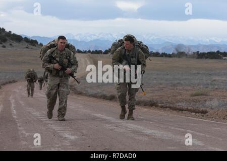 Staff Sgt. Levi McGowan and 2nd Lt. Bryan Tanguay, assigned to Bravo Company, 299th Brigade Engineer Battalion, 1st Stryker Brigade Combat Team, 4th Infantry Division, ruck march to their next event during the Best Sapper Competition, Fort Carson, Colorado, November 28, 2018. This year’s competition includes nine two-person teams from units across Fort Carson. The top three teams will go on to compete in the Army-wide Best Sapper Competition in April 2019. Stock Photo