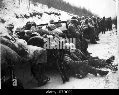 Marines of the 5th and 7th regiments who hurled back a surprise onslaught by three Chinese communist divisions wait to withdraw from the Chosin Reservoir area circa December 1950. Stock Photo