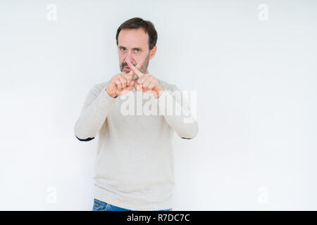 Elegant senior man over isolated background Rejection expression crossing fingers doing negative sign Stock Photo