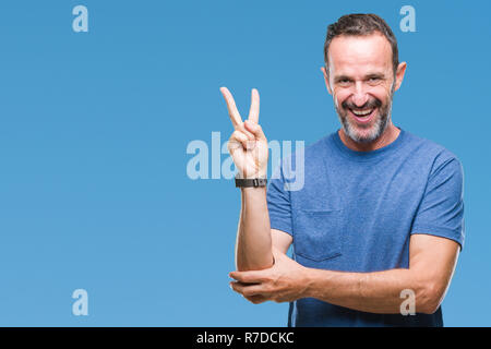 Middle age hoary senior man over isolated background smiling with happy face winking at the camera doing victory sign. Number two. Stock Photo