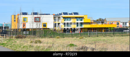 New modern 2012 colourful primary school education building & play area close to Shoebury Garrison housing development Shoeburyness Southend Essex UK Stock Photo