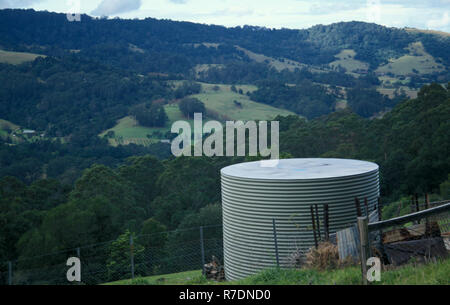 DOMESTIC RAINWATER TANK ON HILLSIDE OF A RURAL PROPERTY IN NEW SOUTH WALES, AUSTRALIA Stock Photo