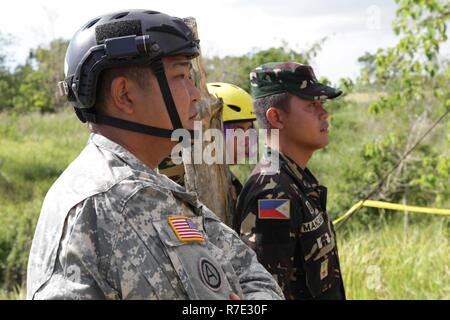 U.S. and Philippine Soldiers watch as Philippine Soldiers rescue injured personnel from a multistory training platform using repel techniques as part of Balikatan 2017 at Camp Dela Cruz, Upi, Gamu, Isabela, May 15, 2017. This training session was the culmination of weeks of training for real world rescue scenarios between the U.S. and the Philippines. Balikatan is an annual U.S.- Philippine military bilateral exercise focused on a variety of missions, including humanitarian assistance and disaster relief, counterterrorism and other combined military operations. Stock Photo