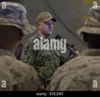 NORFOLK, VA (Nov. 27, 2018) - Commanding Officer, amphibious assault ship USS Bataan (LHD 5), Captain Brad Busch,  speaks to Marines attending Marine Basic School in the ship's well deck. Bataan is currently hosting over two hundred Marine officers while conducting amphibious training and exercises. Stock Photo