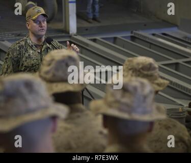 NORFOLK, VA (Nov. 27, 2018)- Commanding Officer, amphibious assault ship USS Bataan (LHD 5), Captain Brad Busch,  speaks to Marines attending Marine Basic School in the ship's well deck. Bataan is currently hosting over two hundred Marine officers while conducting amphibious training and exercises. Stock Photo