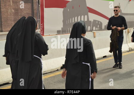 Italy, Rome, October 07, 2018, Nuns in black clothes walking down the street of Rome among tourists Stock Photo