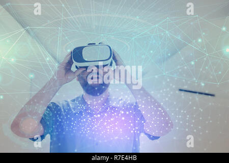 man trying virtual reality vr glasses at modern home with futuristic  neural network  dots graphic design Stock Photo