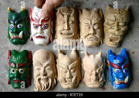 Enshi, Hubei Province, China. 9th December, 2018. A handicraftsman shows the models of masks of Nuo Opera in Enshi City of Tujia-Miao Autonomous Prefecture of Enshi, central China's Hubei Province, Dec. 9, 2018. Nuo Opera, performed with distinguishing masks, is an ancient folk drama which is still popular in some parts of China. Credit: Song Wen/Xinhua/Alamy Live News Credit: Xinhua/Alamy Live News Stock Photo