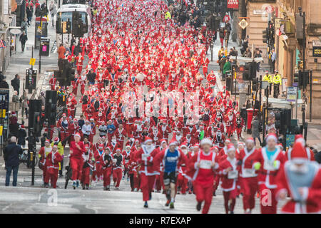 Glasgow, Scotland, UK - 9 December 2018: thousands of santas running through the streets of Glasgow today in the annual Santa Dash Stock Photo