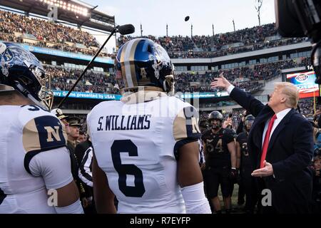 Philadelphia, Pennsylvania, USA. 9th December 2018. U.S President Donald Trump, right, performs the traditional coin toss before the 119th Army Navy game at Lincoln Financial Field December 8, 2018  in Philadelphia, Pennsylvania. Credit: Planetpix/Alamy Live News Stock Photo