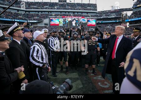 Philadelphia, Pennsylvania, USA. 9th December 2018. U.S President Donald Trump, right, performs the traditional coin toss before the 119th Army Navy game at Lincoln Financial Field December 8, 2018  in Philadelphia, Pennsylvania. Credit: Planetpix/Alamy Live News Stock Photo