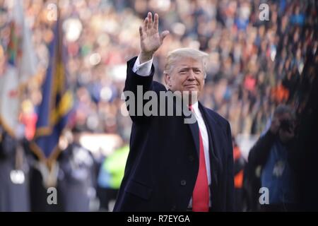 Philadelphia, Pennsylvania, USA. 9th December 2018. U.S President Donald Trump waves as he walks on to the middle of the playing field before the 119th Army Navy game at Lincoln Financial Field December 8, 2018  in Philadelphia, Pennsylvania. Credit: Planetpix/Alamy Live News Stock Photo