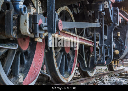 Close-up wheels and parts of vintage steam train locomotive on track Stock Photo