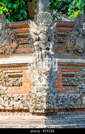 Pura Taman Ayun Temple, sculptures of the Bale basement, wood pavilion, Mengwi, Bali, Indonesia Stock Photo