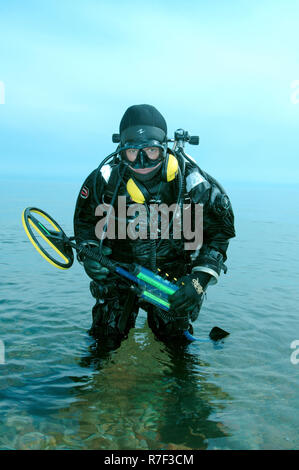 Diver with metal detector searching for underwater treasure, Lake Baikal, Siberia, Russia Stock Photo