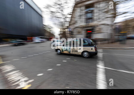 Black cab passes by The High Commission of Australia, the longest established diplomatic mission in London. UK Stock Photo