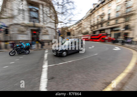 Black cab passes by The High Commission of Australia, the longest established diplomatic mission in London. UK Stock Photo