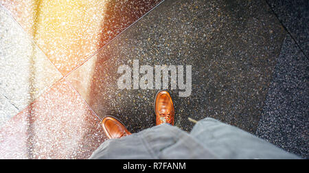 Top view of brown leather shoes. Glare of sunlight on the concrete floor. life Empty background Stock Photo