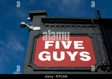 name sign at a branch of the burger restaurant chain five guys, in richmond upon thames, surrey, england Stock Photo