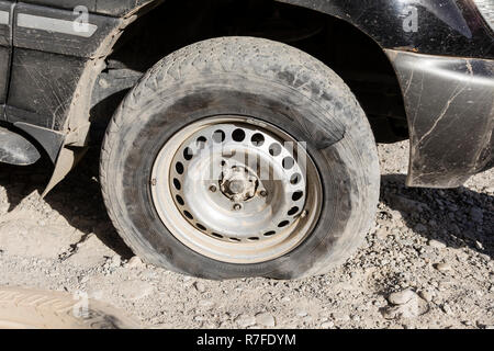 Langar, Tajikistan, August 23 2018: Flat tire on the Pamir Highway near Langar in the border area between Tajikistan and Afghanistan Stock Photo