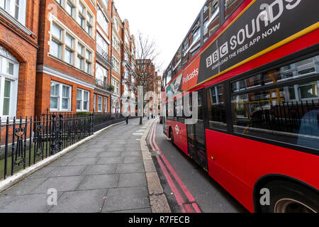 A red London bus at No.1 The Mansions, London. UK Stock Photo