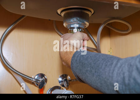 Plumber Install a Sink In kitchen Stock Photo