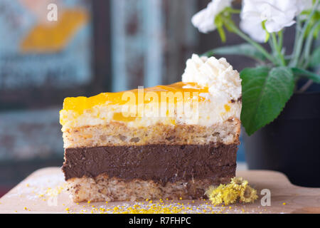 Delicious mango cake on wood with flower Stock Photo