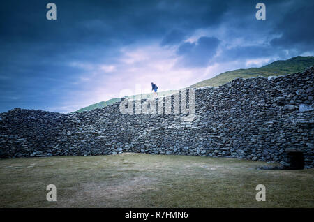 Girl running over the Staigue stone fort, a defensive stronghold built during the iron Age in Sneem, Ireland Stock Photo