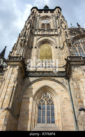 The Cathedral of Saint Vitus (1344) in Prague, Czech Republic, side view architectural detail, with the clock tower and arched windows covered in gold Stock Photo