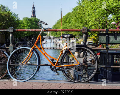 Traditional Dutch bike parked on a canal bridge in Amsterdam, Netherlands Stock Photo