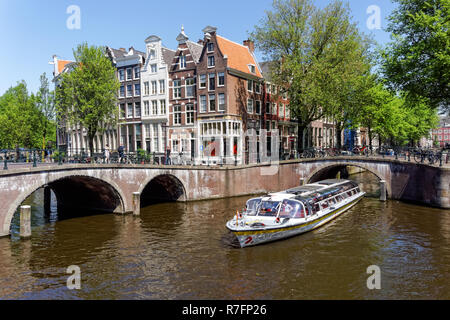 Tourist cruise boat on the Keizersgracht canal in Amsterdam, Netherlands Stock Photo