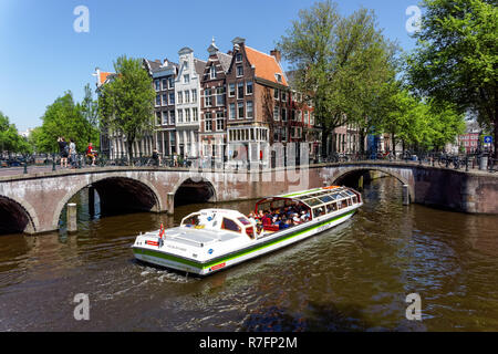 Tourist cruise boat on the Keizersgracht canal in Amsterdam, Netherlands Stock Photo