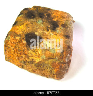 Moldy bread. One slice of wholemeal bread overgrown with food mold fungi on a table in closeup. Stock Photo