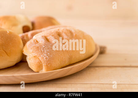 bread in wood plate on the table Stock Photo