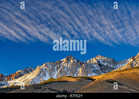 Cirrus clouds over Mt Humphrey in Eastern Sierra Nevada in winter seen from Buttermilk Road near Bishop, California, USA Stock Photo