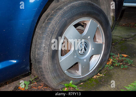 Deflated tyre on a Volkswagen car, UK. Stock Photo