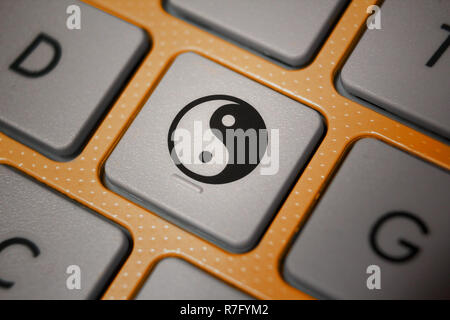 Image of ying-yang icon on computer keyboard Stock Photo