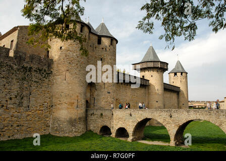 The main gates leading into the castle and moat bridge at Carcassonne. It is a French historical hilltop town with its medieval fortified castle compl Stock Photo