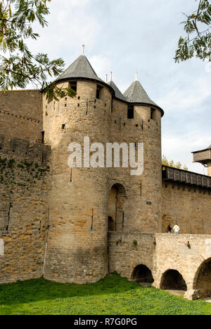 The main gates leading into the castle and moat bridge at Carcassonne. It is a French historical hilltop town with its medieval fortified castle compl Stock Photo