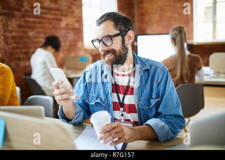 Businessman scrolling in smartphone Stock Photo