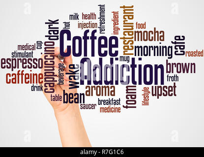 Coffee addiction word cloud and hand with marker concept on white background. Stock Photo