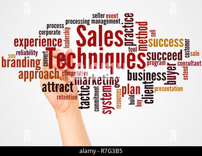 Sales Techniques word cloud and hand with marker concept on white background. Stock Photo