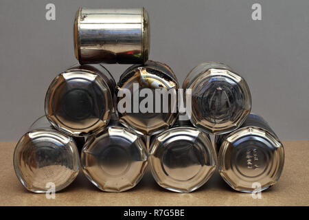 The bunch of full, bulging old tin cans - sick food - garbage Stock Photo