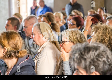 Medjugorje, Bosnia and Herzegovina - November 3, 2018: people praying in church and looking at the altar Stock Photo
